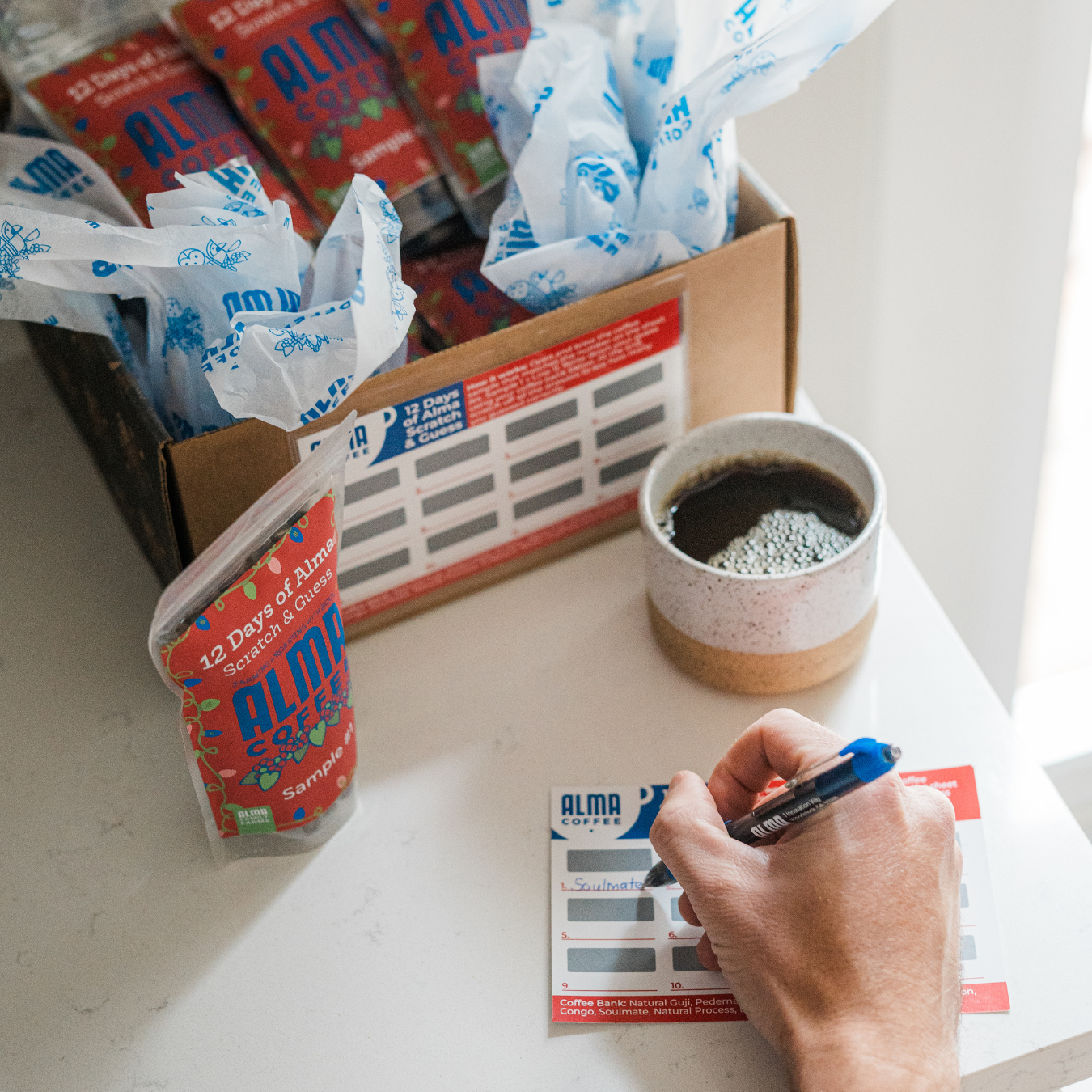 12 sample bags of coffee for alma advent calendar that include a scratch and guess game