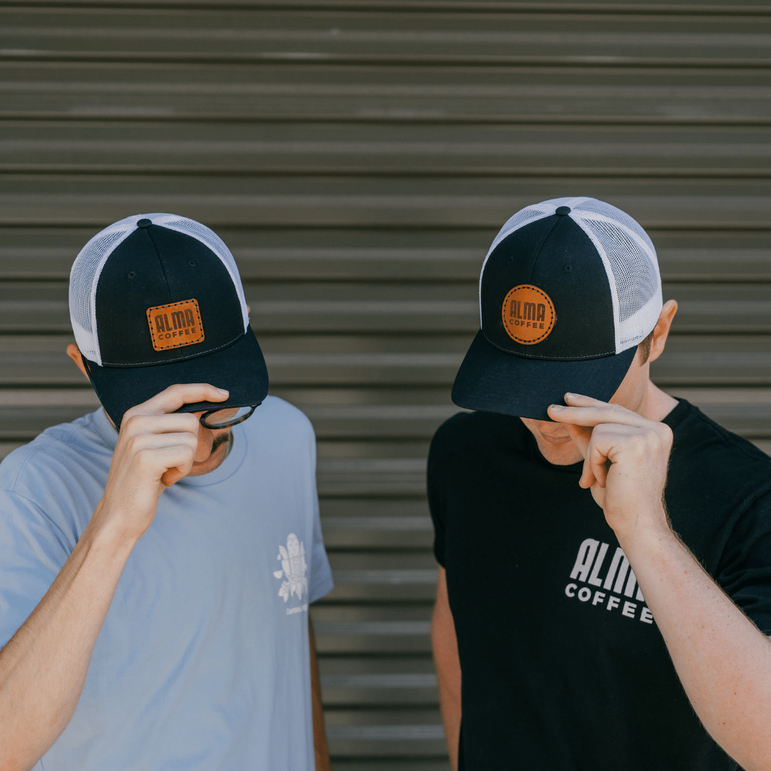 Alma Coffee logo on trucker hat in both circle and rectangle shape Edit alt text