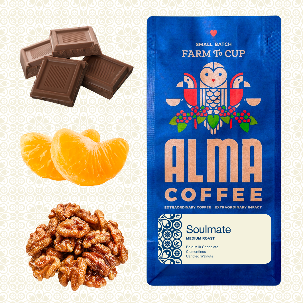 A blue bag of Alma Coffee Soulmate medium roast coffee is shown next to ingredient illustrations of chocolate bars, orange slices, and walnuts on a light patterned background.