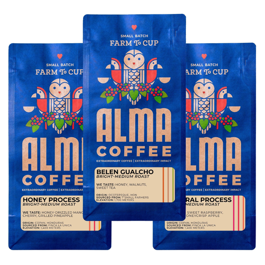 Three packages of Alma Coffee with blue and white design on a white background