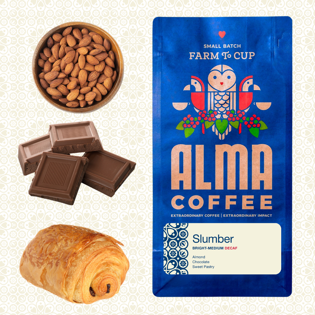 Alma Coffee 'Slumber' medium decaf coffee bag shown next to ingredient illustrations of almonds, chocolate squares, and a croissant on a light patterned background.
